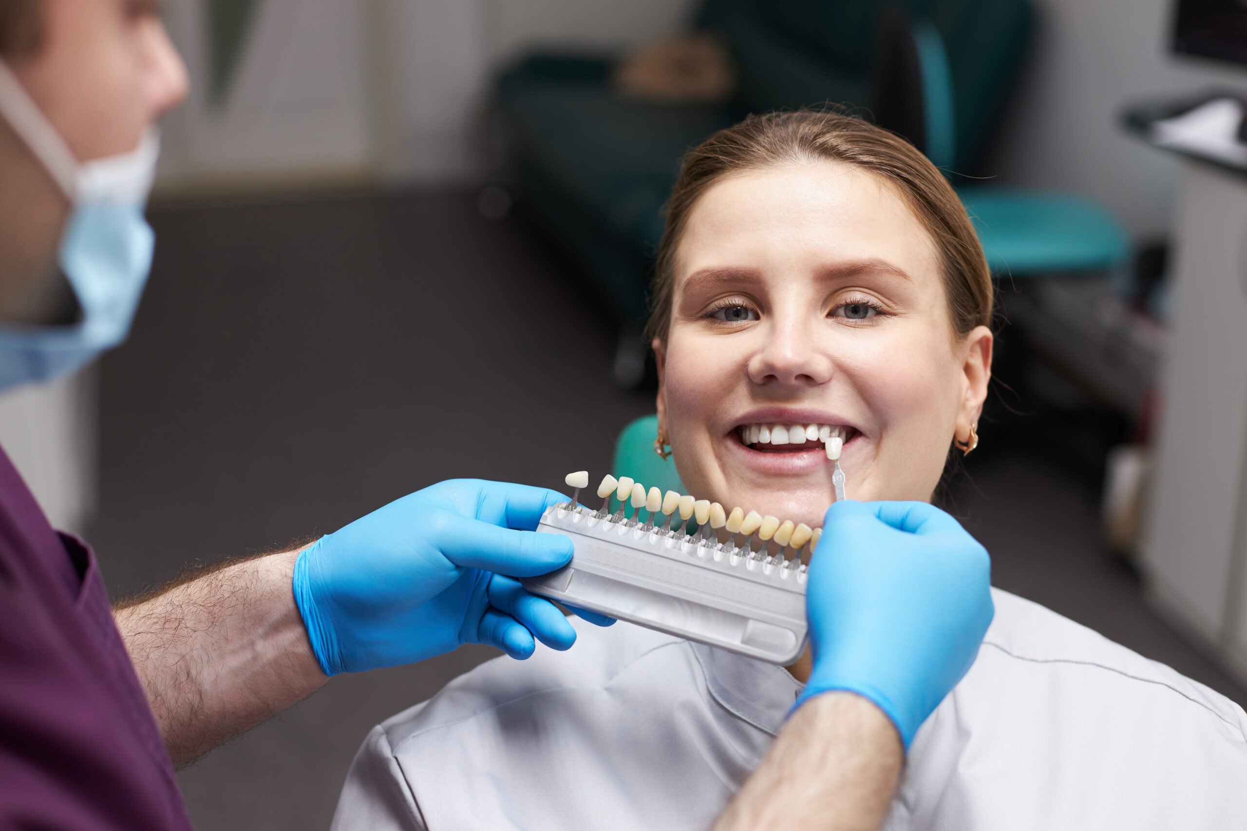 Female patient choosing the shade of dental veneers by 24 Street Dental in phoenix, AZ